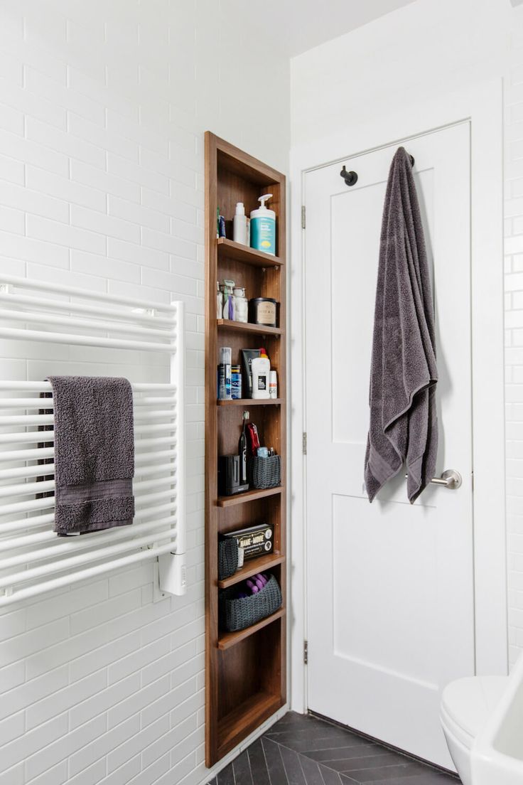 a bathroom with a towel rack next to a toilet