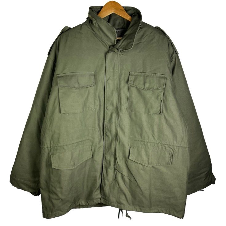 This Rothco M-65 Military Field Jacket Is A Versatile Piece Perfect For Any Occasion. Made Of A Cotton Blend Fabric With A Polyester Lining, This Jacket Is Both Heavyweight And Comfortable. It Features A Full Zip Closure With Button And Loop Accents, Along With Zipped Pockets And A Collared Neckline. The Jacket Is Lined With Removable Lining And Insulated With Polyester, Making It Perfect For Winter, Fall, And Spring Seasons. The Olive Green Color Adds A Touch Of Nature And Military Style, While Military Outerwear With Flap Pockets, Tactical Long Sleeve Solid Outerwear, Military Style Winter Windbreaker With Flap Pockets, Military Style Windbreaker With Flap Pockets For Winter, Khaki Combat Outerwear For Fall, Combat Style Long Sleeve Outerwear For Streetwear, Combat Style Long Sleeve Streetwear Outerwear, Military Style Windbreaker For Cold Weather, Fall Combat Parka For Streetwear