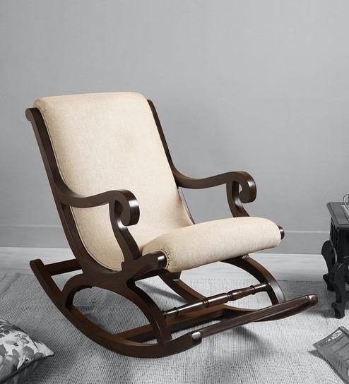 a rocking chair sitting on top of a white rug