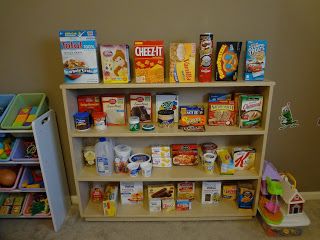 a book shelf filled with lots of children's books next to a toy car