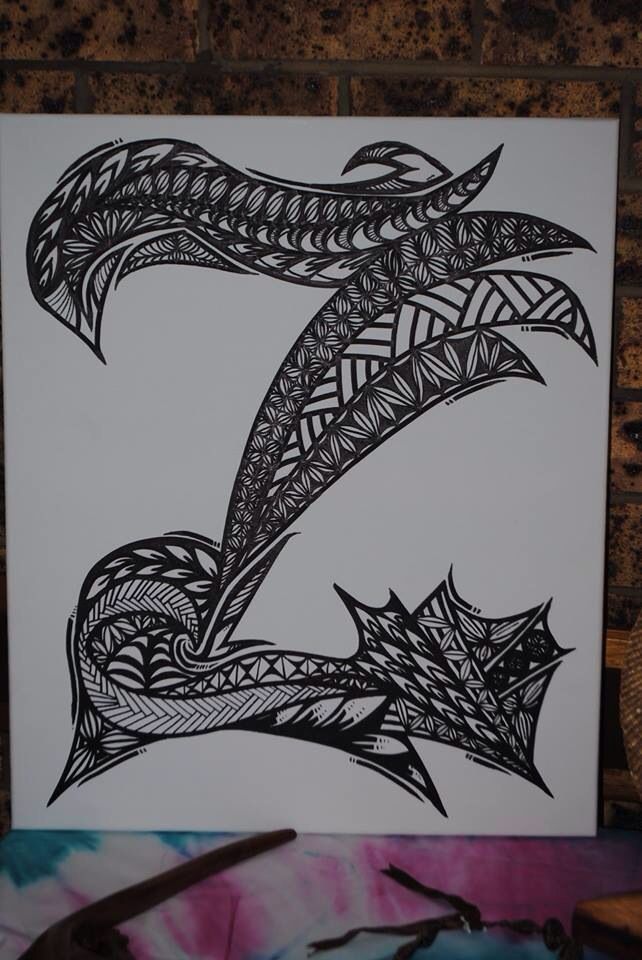 a black and white drawing of a snake on a piece of paper with scissors next to it