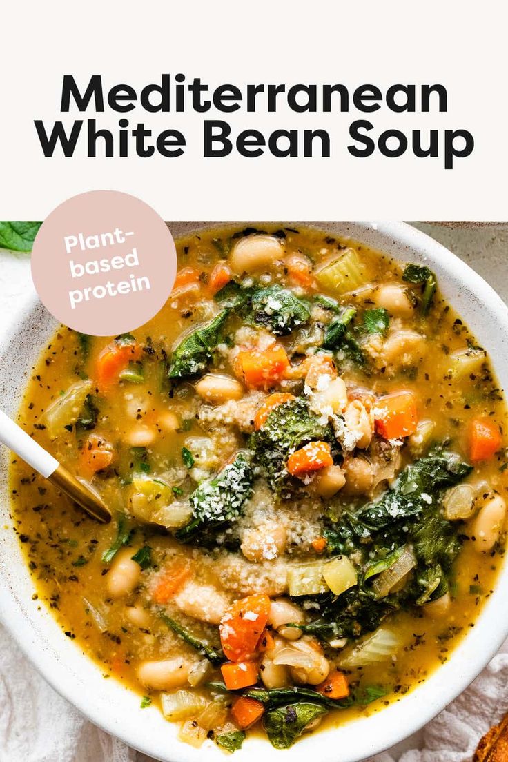 a bowl of white bean soup with broccoli, carrots and spinach