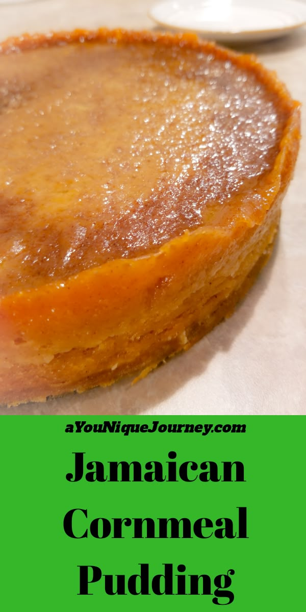 a close up of a pie on a table with the words jamaican cornmeal pudding