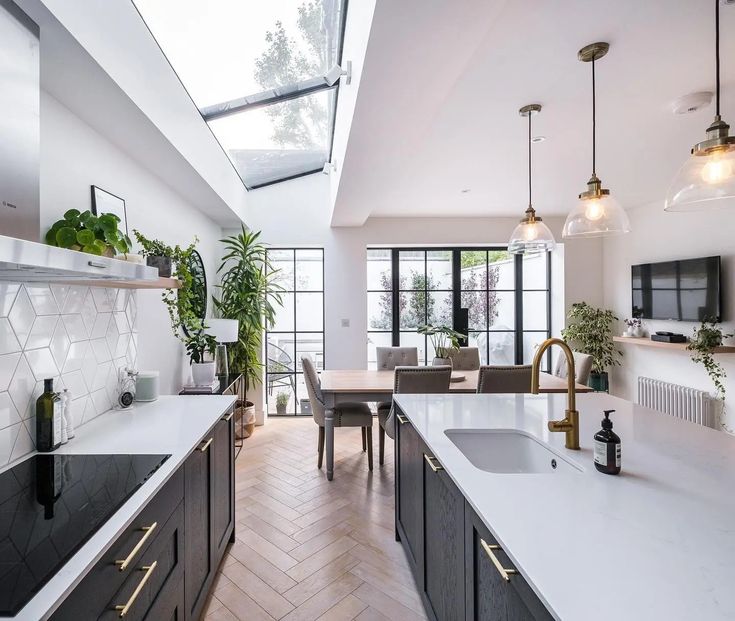 a kitchen with white counter tops and black cabinets