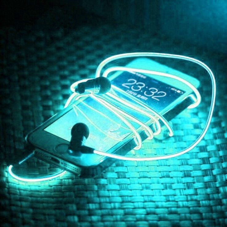 a cell phone that is sitting on a table with some neon lights attached to it