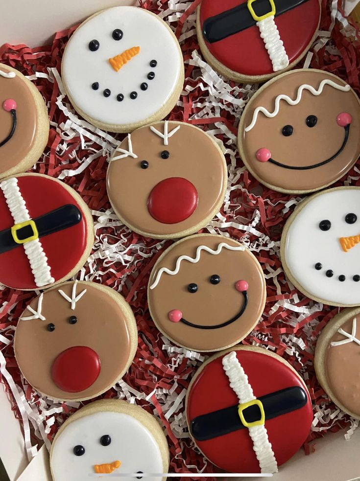 decorated cookies in a box with santa clause on them