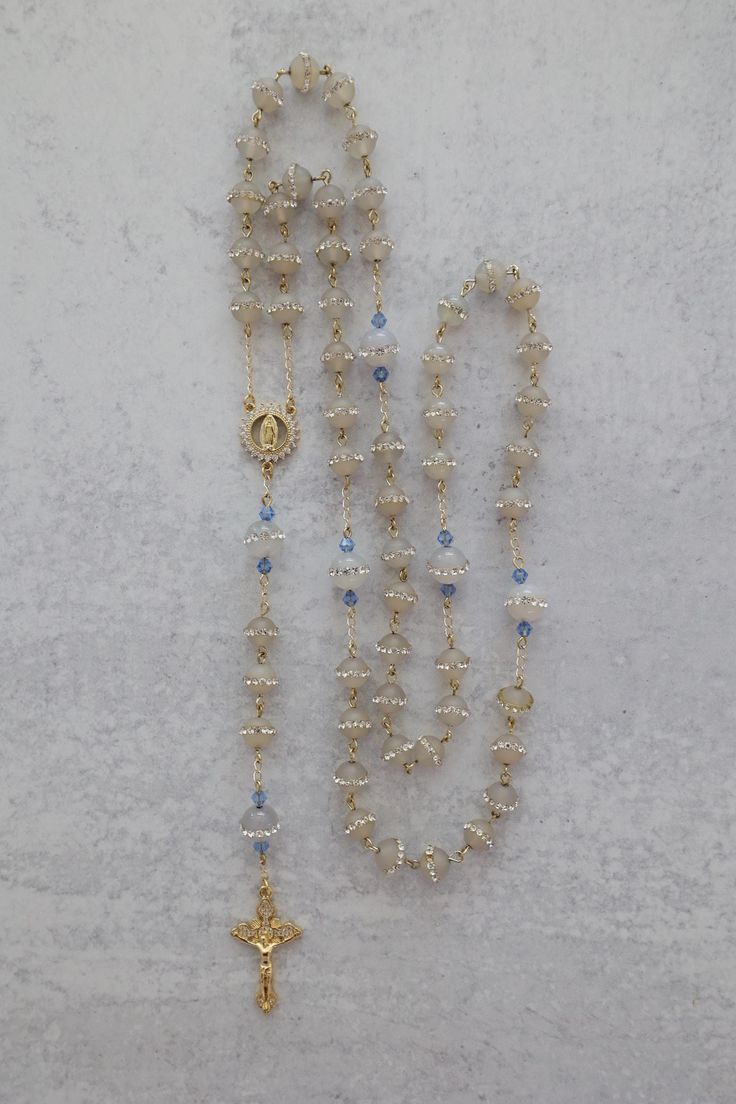 Something Blue Wedding Rosary | 14K Gold Filled with Crystal Beads | Catholic Wedding Gift Add a touch of elegance and tradition to your special day with this stunning Something Blue Wedding Rosary. Crafted with 14K gold-filled details and sparkling crystal beads, this rosary makes a beautiful and meaningful gift for the bride. A perfect keepsake for a Catholic wedding, it features an intricately detailed Virgin Mary centerpiece, symbolizing love, faith, and devotion. Whether for prayer or as a Vintage Catholic Jewelry, Blue Catholic Aesthetic, Elegant Beaded Wedding Rosary, Mexican Catholic Aesthetic, Catholic Wedding Aesthetic, Rosary Display, Bridal Rosary, Rosary Aesthetic, Traditional Catholic Wedding