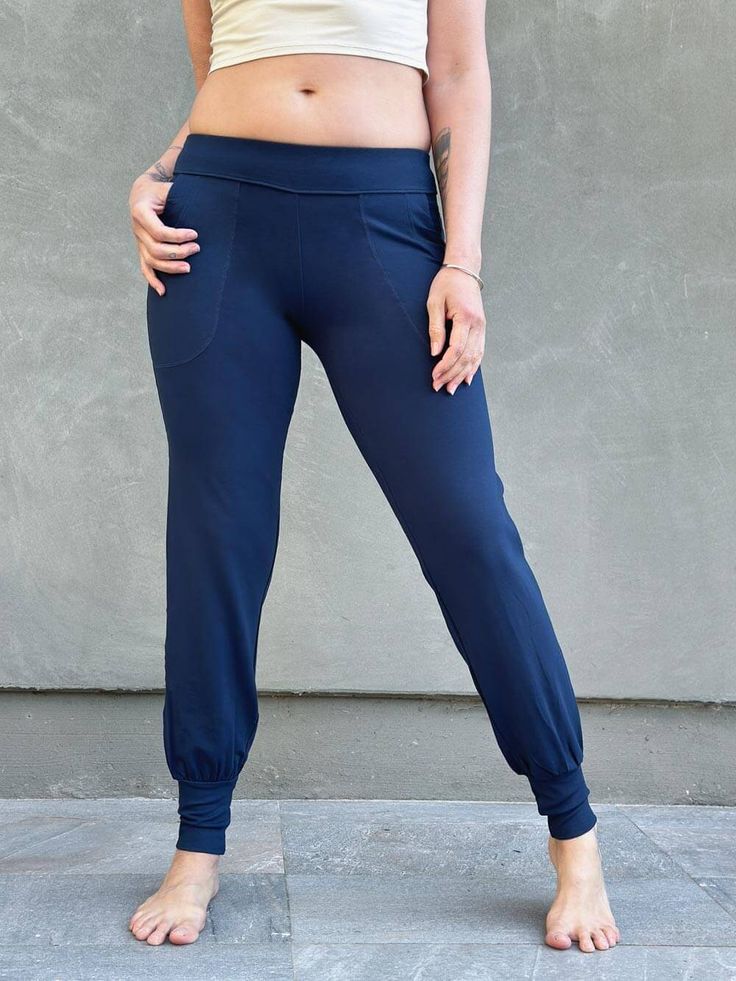 women's bamboo spandex navy blue jogger pants with two front pockets #color_navy Solid Ankle-length Athleisure Joggers, Versatile Activewear With Pockets For Loungewear, Stretch Sweatpants With Pockets For Yoga, Solid Sweatpants With Pockets For Yoga, Casual Yoga Pants With Elastic Side Panels, Sporty Yoga Sweatpants With Elastic Waistband, Solid Color Yoga Activewear For Loosely Fitted Hips, Sporty Sweatpants With Elastic Waistband For Yoga, Yoga Pants With Side Pockets And 4-way Stretch