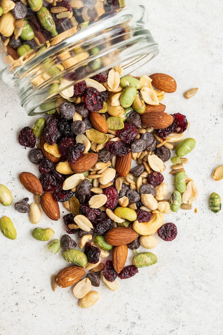 mixed nuts and cranberries in a glass jar