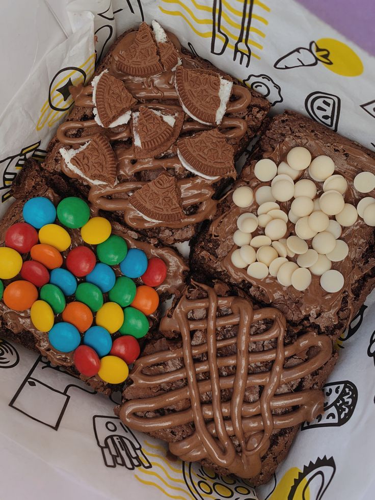 an assortment of cookies, marshmallows, and chocolate on a paper plate