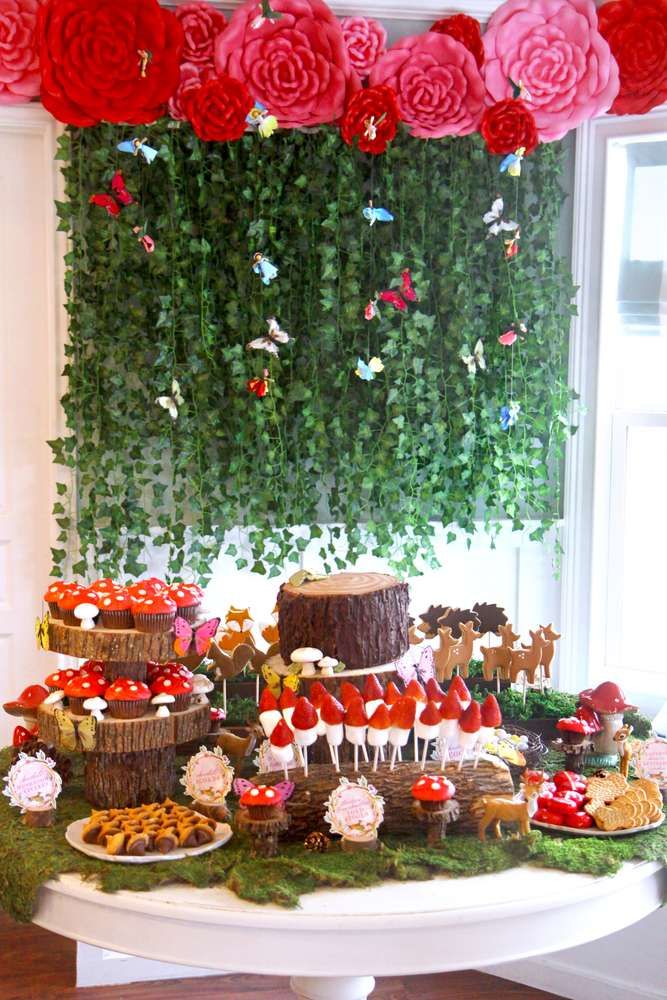 a table topped with lots of cakes and desserts