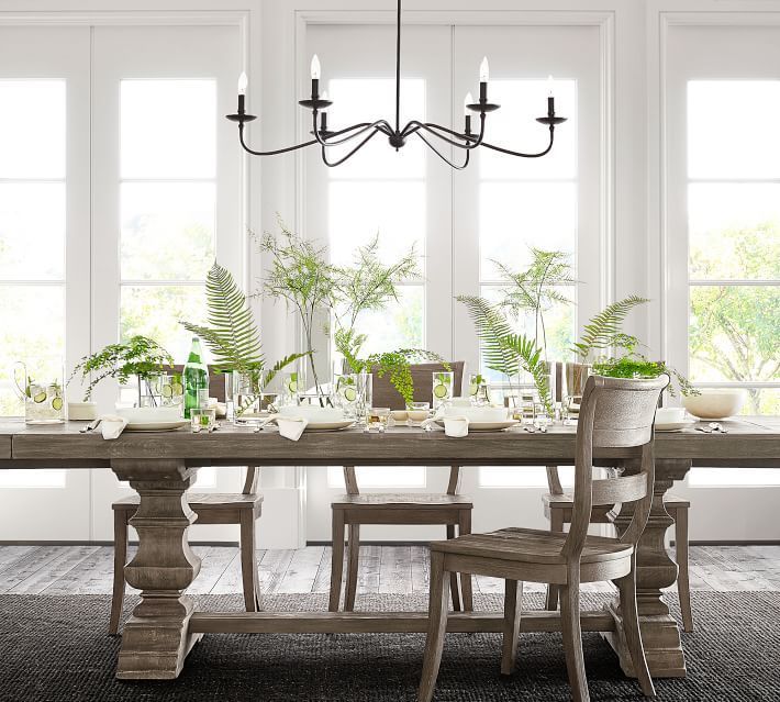 a dining room table and chairs with plants on the tables in front of them,