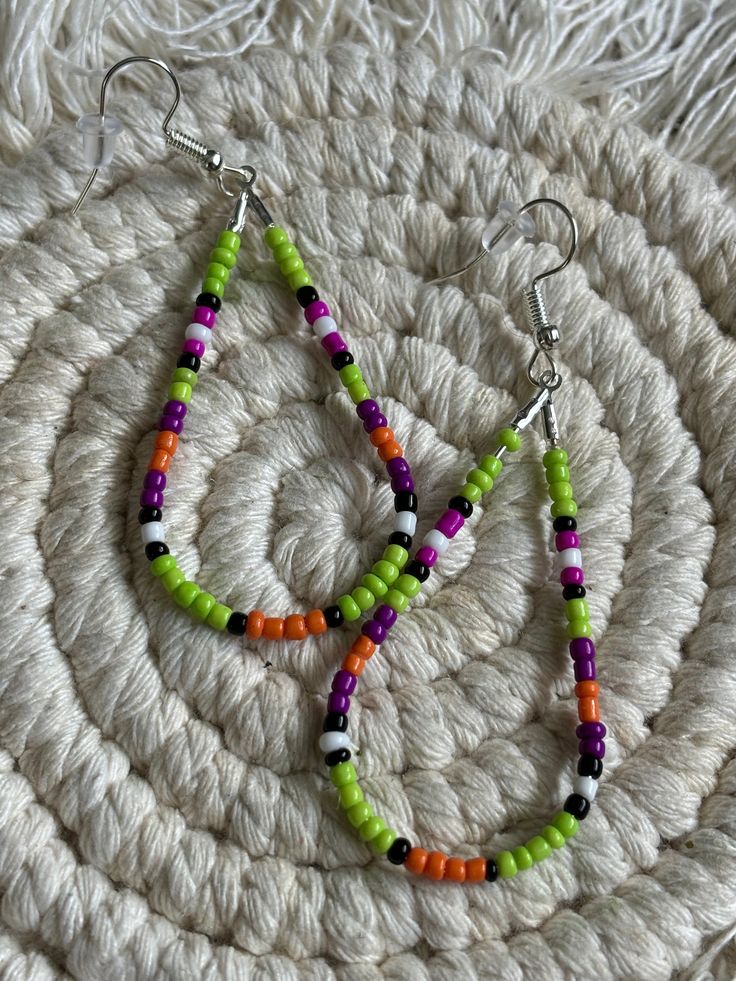 Lime green colored teardrop loop dangle earrings. Made with multicolored glass seed beads attached to a hypoallergenic earring ring fixing. Trendy Multicolor Handmade Teardrop Earrings, Colorful Beaded Dangle Teardrop Earrings, Trendy Handmade Teardrop Beaded Earrings, Multicolor Beaded Teardrop Earrings, Multicolor Teardrop Earrings With Dangling Beads, Trendy Teardrop Beaded Earrings As Gift, Colorful Beads Teardrop Earrings, Green Teardrop Beaded Earrings With Dangling Beads, Trendy Teardrop Dangling Bead Jewelry