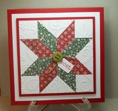 a close up of a christmas card with a star on the front and a button in the middle