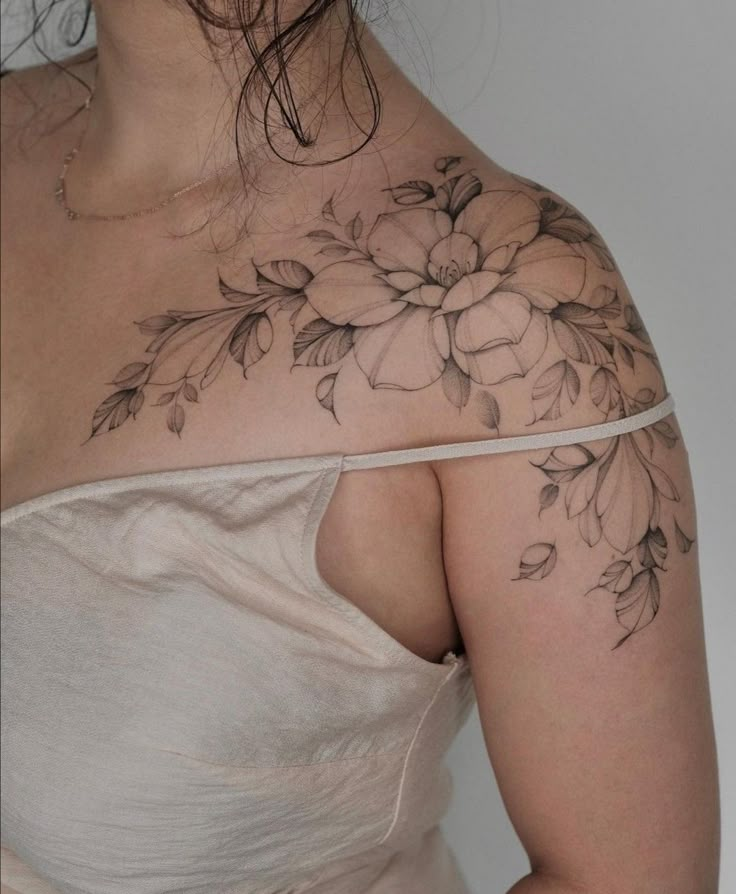 a woman with a flower tattoo on her shoulder