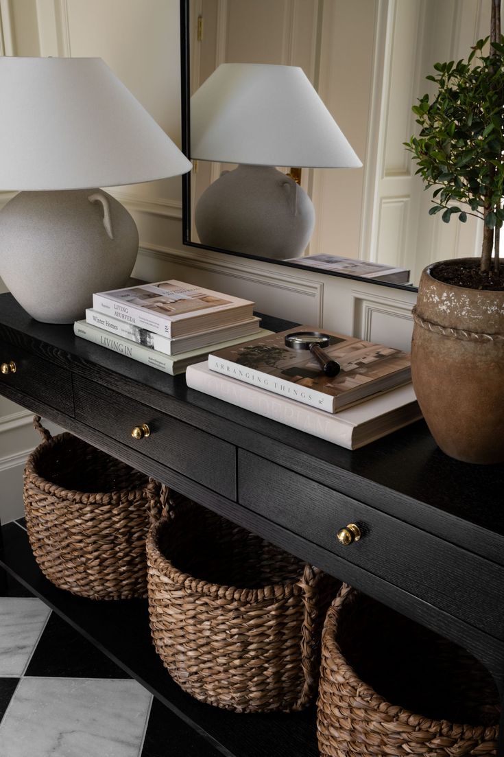 a black table with two baskets and a lamp