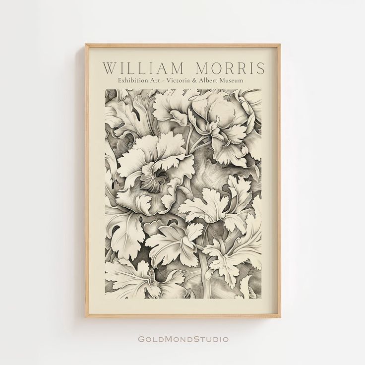 a book cover with flowers on it in a wooden frame against a white wall background