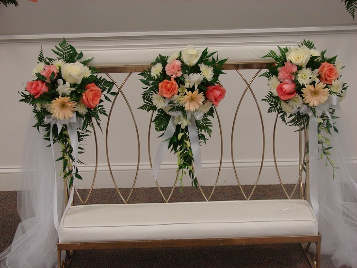 flowers are arranged on the back of a bench