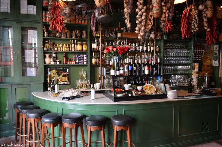 a bar with lots of bottles and stools