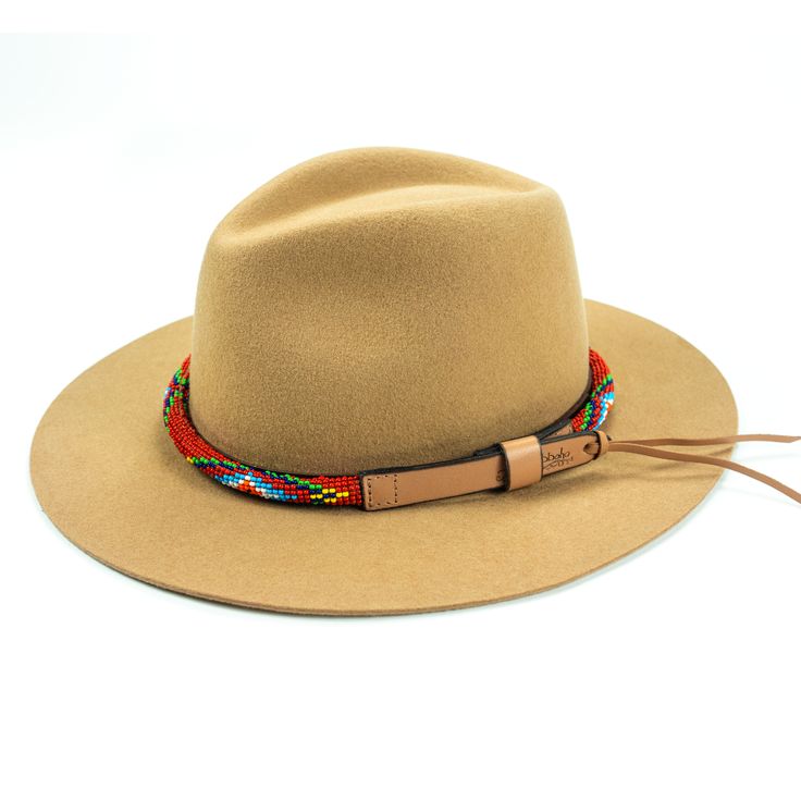 Price includes a Lola Sambboho hat & a Red Vogue hatband. Save 10% with this bundle. Select hat size. Hatband is one size fits all. Hatband is removable. An iconic must-have Fedora hat that will never get out of fashion. Sambboho's Lola hat has a soft brim and indented crown. A chic piece to be worn at all seasons of the year. The timelessness chic and sophistication exuded by this hat make it a lifetime wardrobe investment you’ll never regret! Classic Fedora design in Sand color Trimmed wit Adjustable Brimmed Straw Hat For Fall, Adjustable Straw Hat With Flat Brim For Fall, Multicolor Fedora With Short Brim For Rodeo, Adjustable Fedora Straw Hat For Fall, Multicolor Short Brim Fedora For Rodeo, Bohemian Fedora Straw Hat, Bohemian One-size Fedora Straw Hat, Adjustable Bohemian Straw Hat For Travel, Adjustable Red Hat Bands For Summer