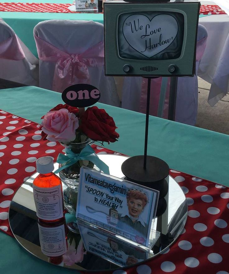 a table topped with a cake covered in frosting next to a vase filled with flowers