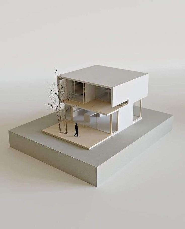 a model of a house on top of a platform with a tree in the middle