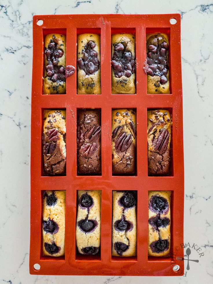 an orange tray filled with blueberry and chocolate muffins