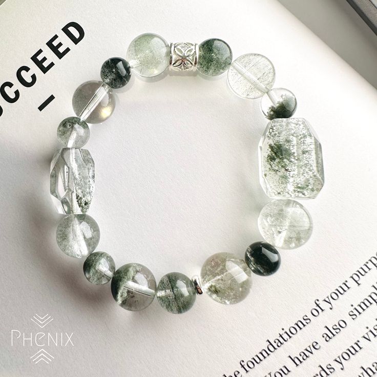 Green Phantom Quartz design with 925 silver bead Support your energy for career development. The bracelet is design in 15.5-16cm, if you need to adjust the size please let us know :) EMBRACE THE CREATION OF MOTHER NATURE Every piece of crystal is the creation of nature, there might be slightly difference and nature inclusion. We try our best to control every item same with the photo shown. FOLLOW US! Follow us on Facebook and Instagram to get updates: @PhenixCrystalShop VISIT US! Come to visit u Casual Silver Round Crystal Bracelet, Silver Adjustable Crystal Bracelet For Meditation, Casual Silver Crystal Bracelet With Round Beads, Casual Silver Bracelets With Gemstone Beads, Sterling Silver Crystal Bracelet With Round Beads For Healing, Silver Healing Stretch Bracelet, Modern Silver Bracelets With Gemstone Beads, Hypoallergenic Silver Bracelets For Meditation, Silver Hypoallergenic Stretch Bracelet