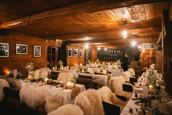 a room filled with tables covered in white tablecloths