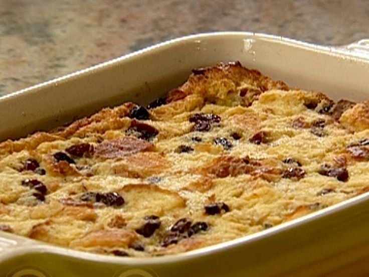 a casserole dish with raisins and cheese in it on a table