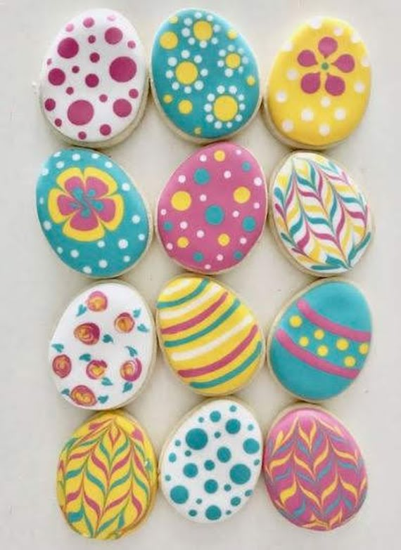 several decorated rocks sitting on top of a white table next to each other with different designs