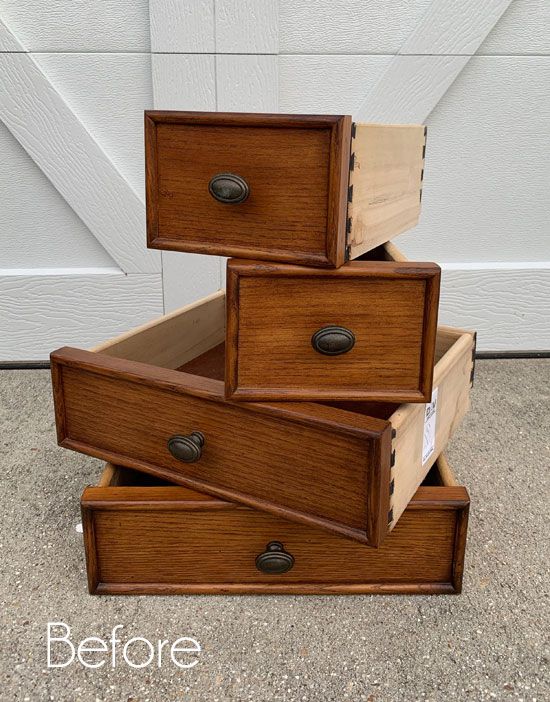 three drawers stacked on top of each other in front of a garage door with the bottom drawer open