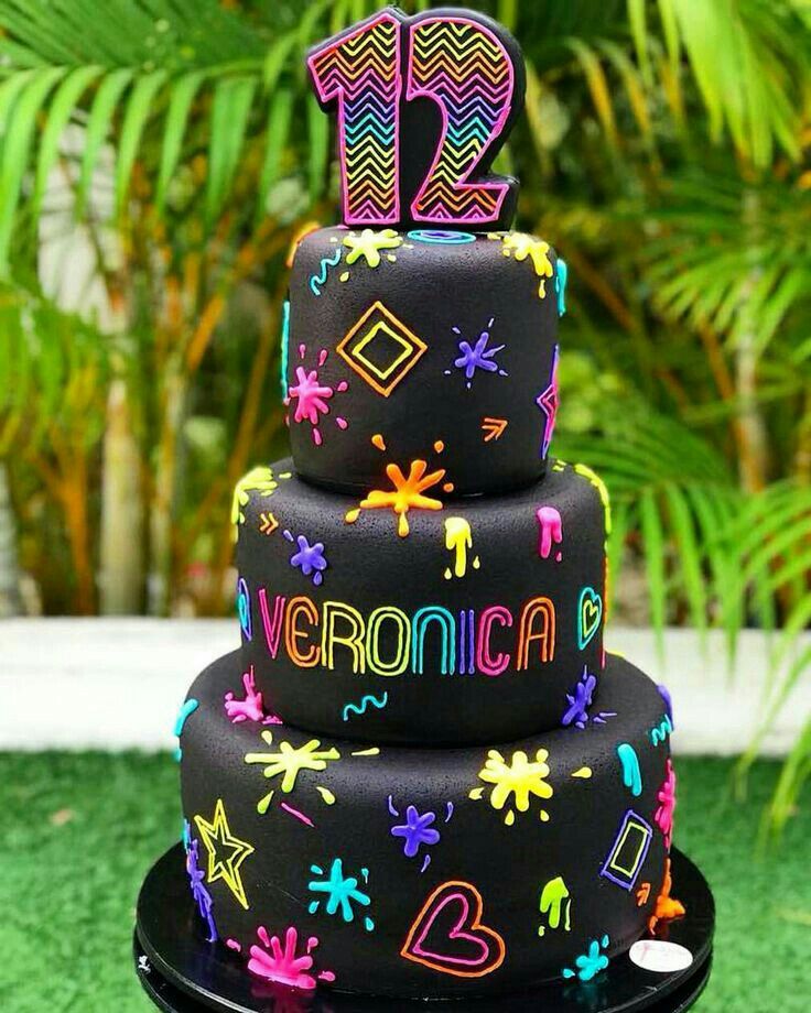 a three tiered cake decorated with neon colors