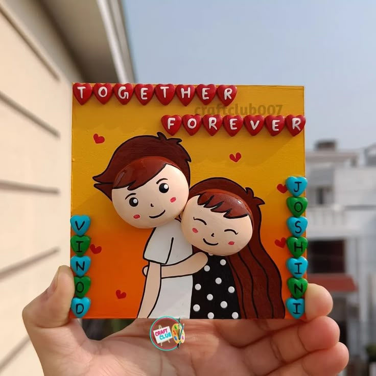 a hand holding up a card with an image of two people on it and the words together