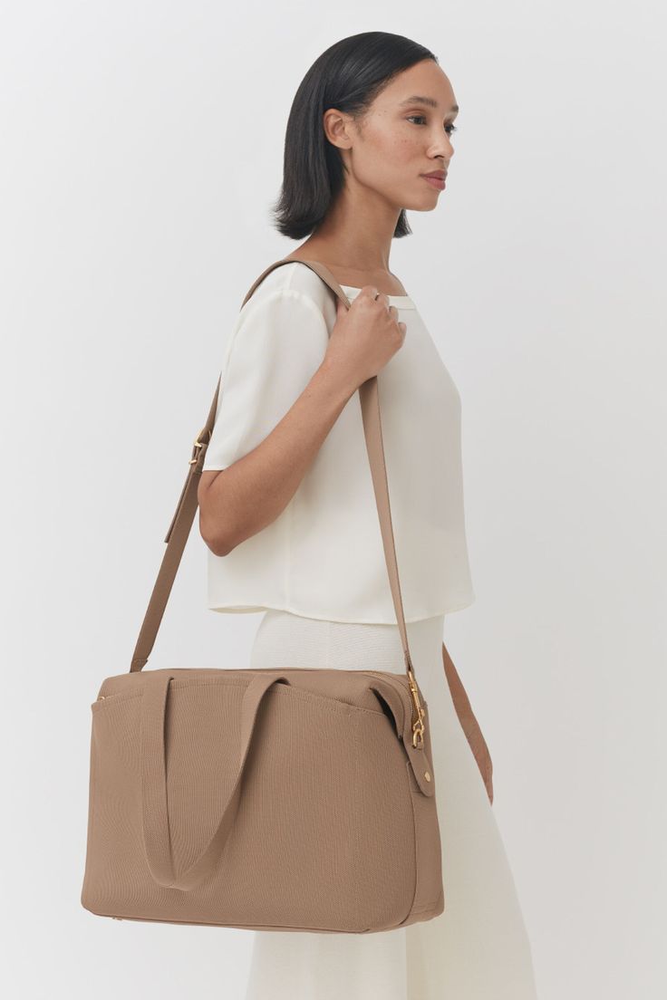 Recycled Overnight | Cuyana Everyday Tote Satchel With Luggage Sleeve, Beige Shoulder Bag With Luggage Sleeve For On-the-go, Chic Everyday Duffle Bag With Luggage Sleeve, Everyday Beige Travel Bag With Detachable Strap, Chic Duffle Bag With Luggage Sleeve, Beige Satchel Weekender Bag, Beige Weekender Bag For On-the-go, Beige Laptop Bag With Luggage Sleeve For Everyday Use, Chic Beige Weekender Bag For On-the-go