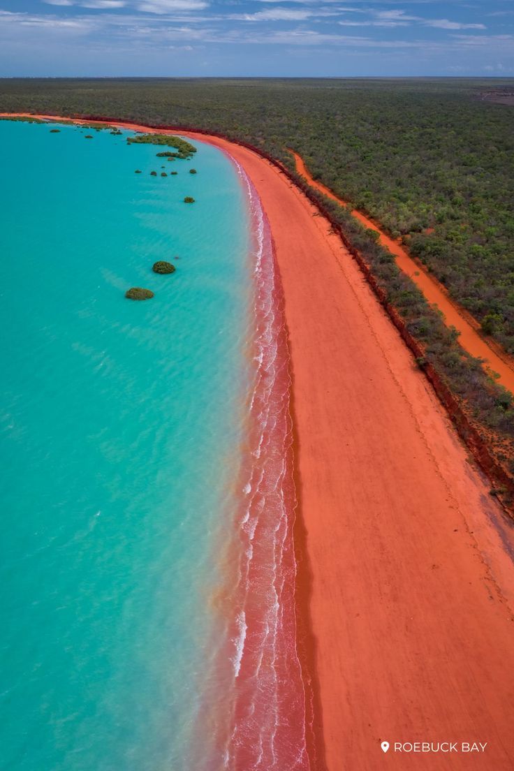 an aerial view of the red sand and blue water in australia's outback