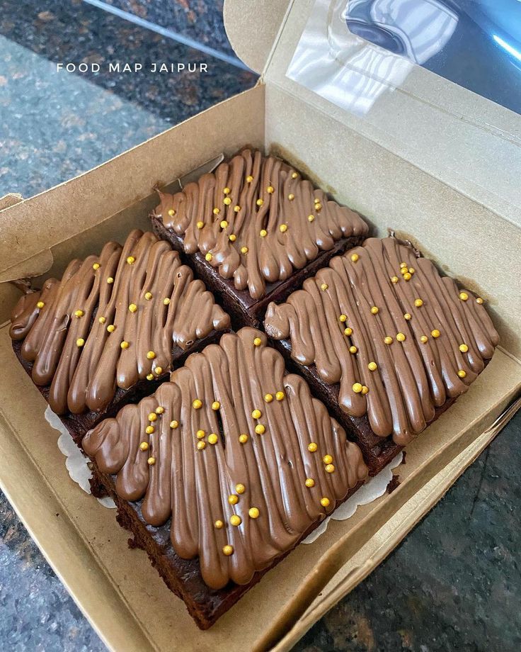 a box filled with brownies covered in frosting