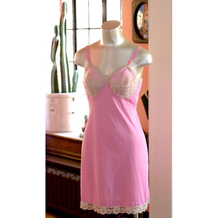 Hi, Barbie! Gorgeous vintage 1960s mini slip dress/nighty by Gossard Artemis.  Bright pink with amazing off-white lace details on the cups and trim.  The label says it is size "34 short" so maybe that means it's 34C or 34D - I wish it just said - but it doesn't, so please see the photos and the measurements. It is shown on a size small mannequin form, so I would say it fits like a modern medium. Straps are adjustable.  LAYING FLAT bust (pit to pit): 16" cups: C or D (about 8" across the seam of Fitted Coquette Chemise For Bedtime, Feminine Fitted Slip Dress For Bedtime, Pink Sleeveless Chemise For Wedding Night, Sleeveless Pink Chemise For Wedding Night, Vintage Pink Slip Dress With Lace Trim, Vintage Pink Slip Dress For Daywear, Vintage Camisole Sleepwear For Bedtime, Vintage Camisole Sleepwear, Pink Fitted Chemise For Wedding Night