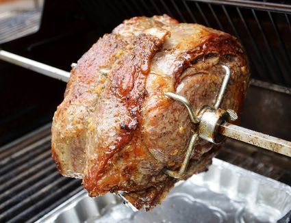 a piece of meat is being cooked on the grill