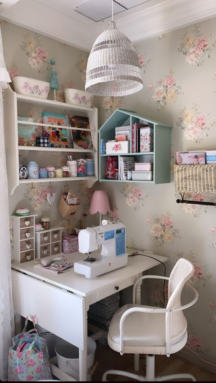 a white desk with a sewing machine on top of it next to a shelf filled with craft supplies