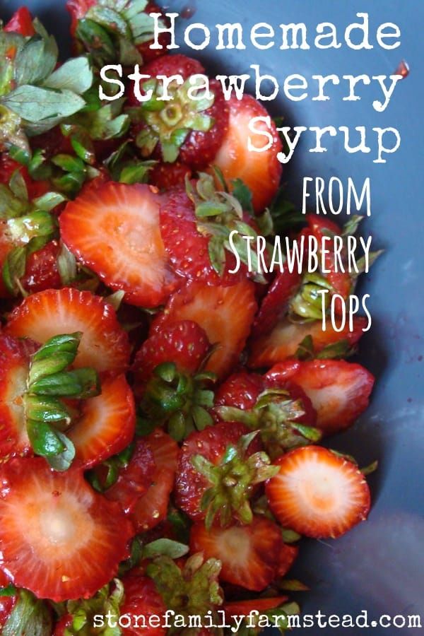 strawberries in a blue bowl with the words homemade strawberry syrup from strawberry tops