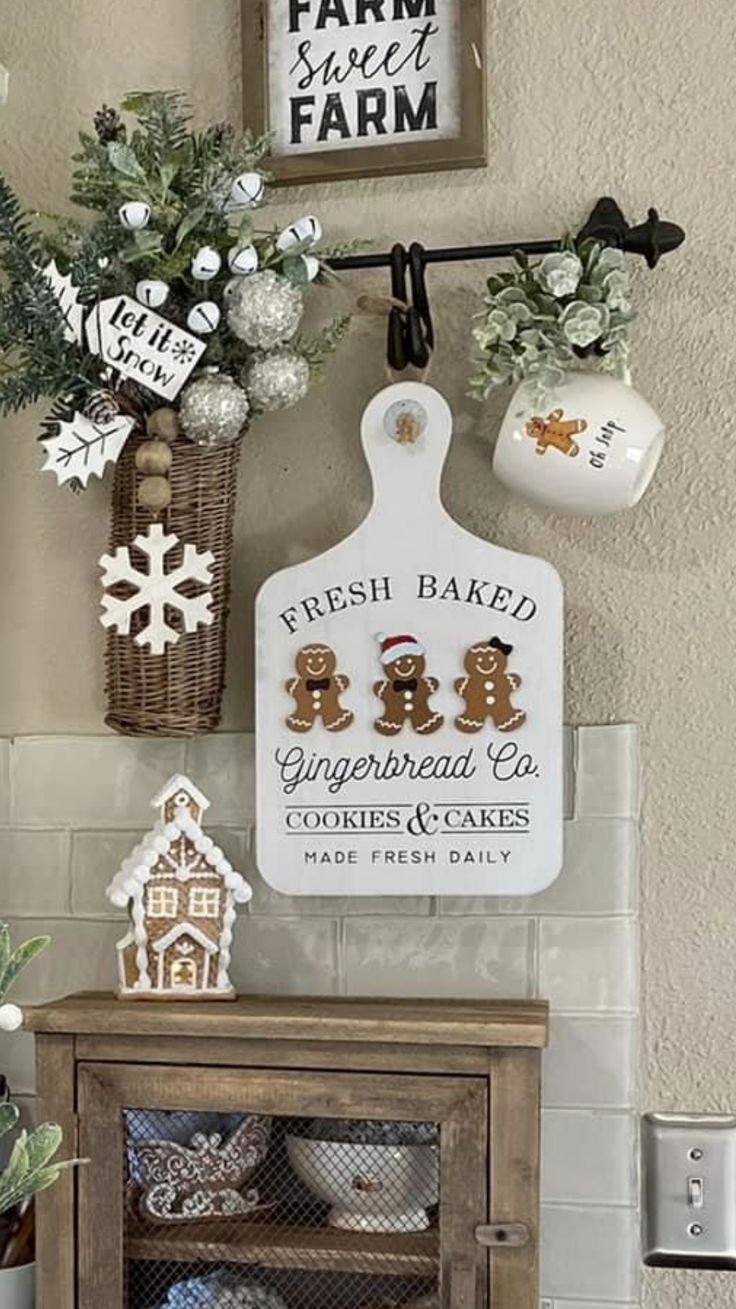 a wooden cabinet topped with christmas decorations and gingerbreads on it's side