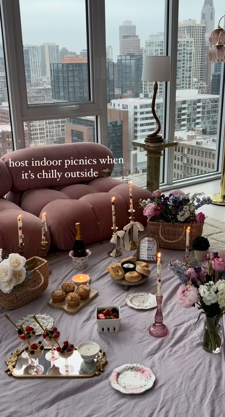 a living room filled with lots of furniture next to a window covered in flowers and candles