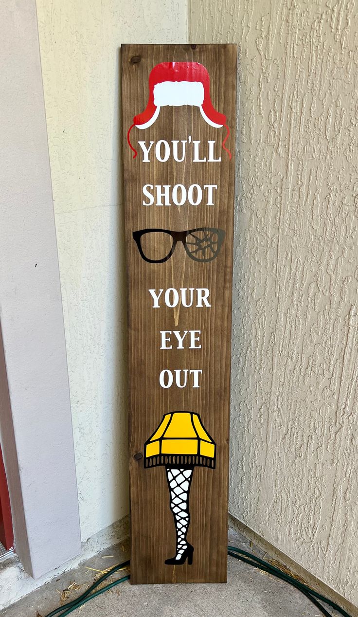 a wooden sign that says, you'll shoot your eye out on the floor