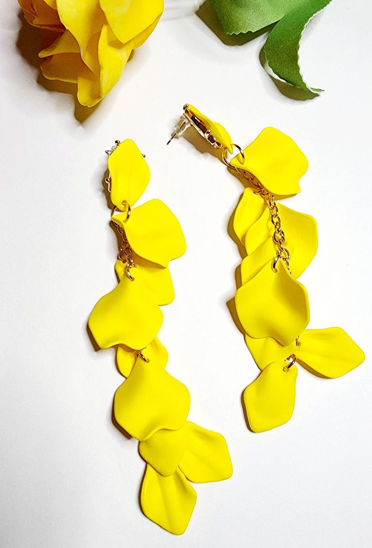 Treat yourself or surprise someone special with these exquisite earrings that are as beautiful as they are versatile. Don't miss out on the opportunity to express your individuality and embrace your inner fashionista, get yours today and let your style blossom! Trendy Adjustable Drop Clip-on Earrings, Spring Party Jewelry With Matching Earrings, Spring Party Dangle Jewelry, Yellow Trendy Flower Earrings For Party, Trendy Yellow Flower Earrings For Party, Elegant Hypoallergenic Yellow Earrings, Yellow Jewelry With Ear Wire For Party, Party Jewelry With Yellow Ear Wire, Party Clip-on Flower Shaped Earrings