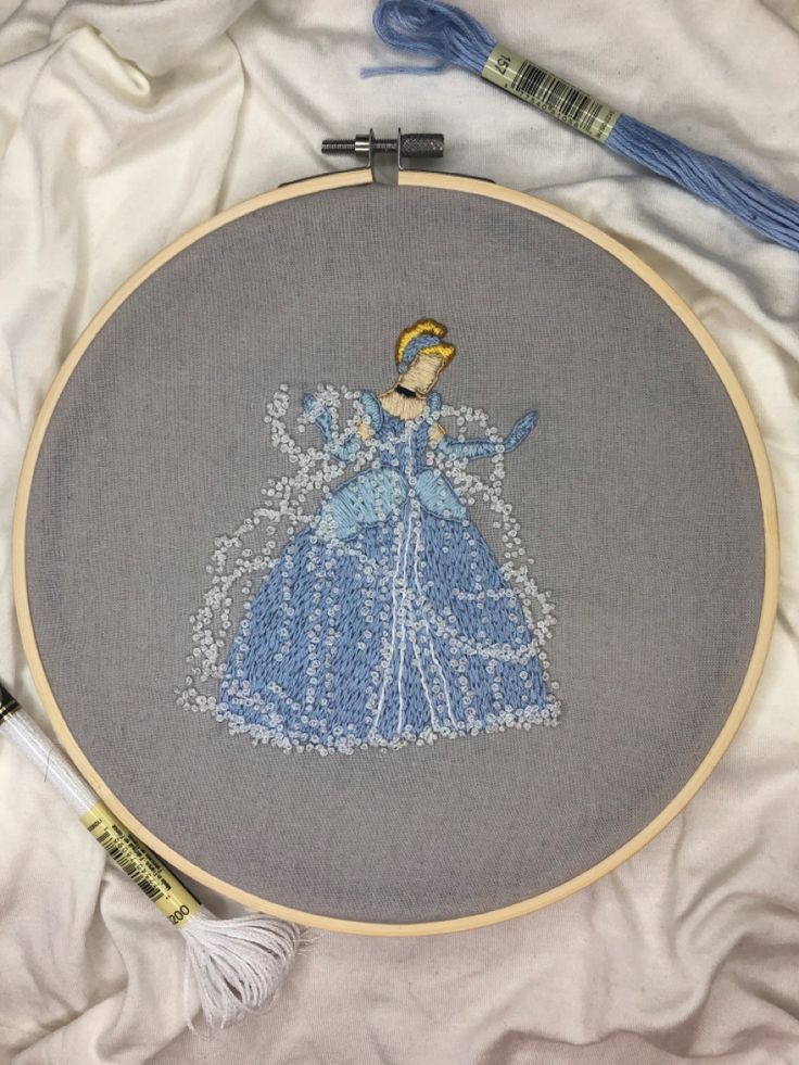 the embroidery is being worked on by someone who has done something with yarn and thread