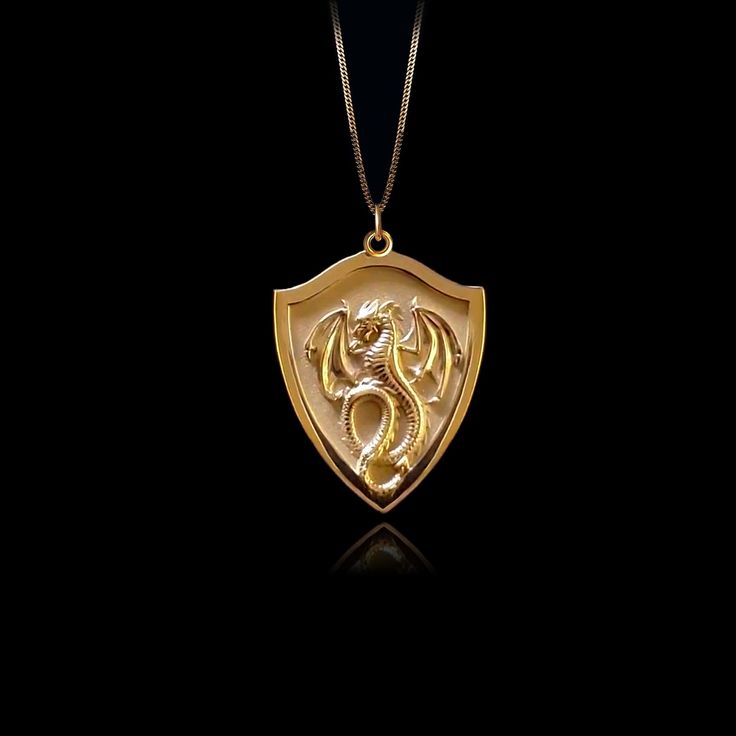 Unleash your inner fire with our Dragon pendant. Crafted with exquisite detail, this powerful piece embodies the untamed strength and mystique of the dragon, a symbol of wisdom and fierce protection. Feel the energy of this ancient guardian as it wraps you in its embrace, reminding you of your own unyielding spirit and the burning passion within. PENDANT INFORMATION This pendant is made of real, solid gold.• Made in USA• Material: 14k or 18k solid gold• Finish: polished• Height: 1.2" (30,5 mm) x Gold Fantasy Style Necklace For Fantasy Events, Luxury Gold Dragon Design Jewelry, Gold Necklace With Dragon Design Collectible, Luxury Gold Jewelry With Dragon Design, Spiritual Gold Jewelry With Dragon Design, Luxury Dragon Design Jewelry For Gift, Symbolic Gold Dragon Jewelry, Gold Pendant Fantasy Necklace, Symbolic Gold Jewelry With Dragon Design