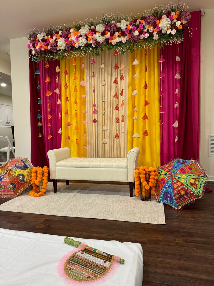 a decorated stage with flowers and umbrellas