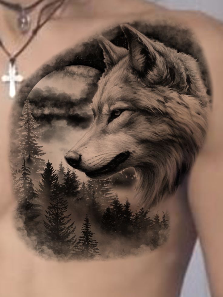 a man's chest with a wolf tattoo on it and trees in the background