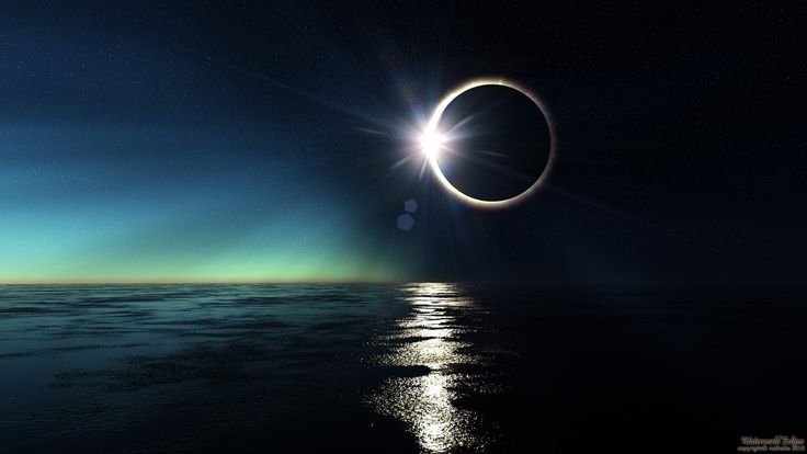 an eclipse is seen over the ocean at night